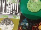 2  x UK Subs singles (CID, yellow vinyl) & (She's Not There, green vinyl).