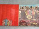 The Beatles Sgt. Peppers Lonely Hearts Club Band LP with unused cut-outs.